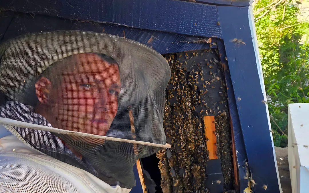 Eli in his bee suit beside an opened wall in Rancho Cucamonga