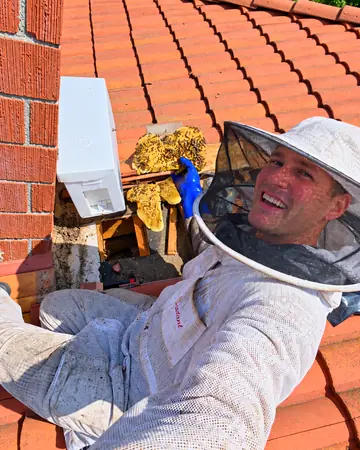 Eli on a tile roof by a chimney in Walnut, CA